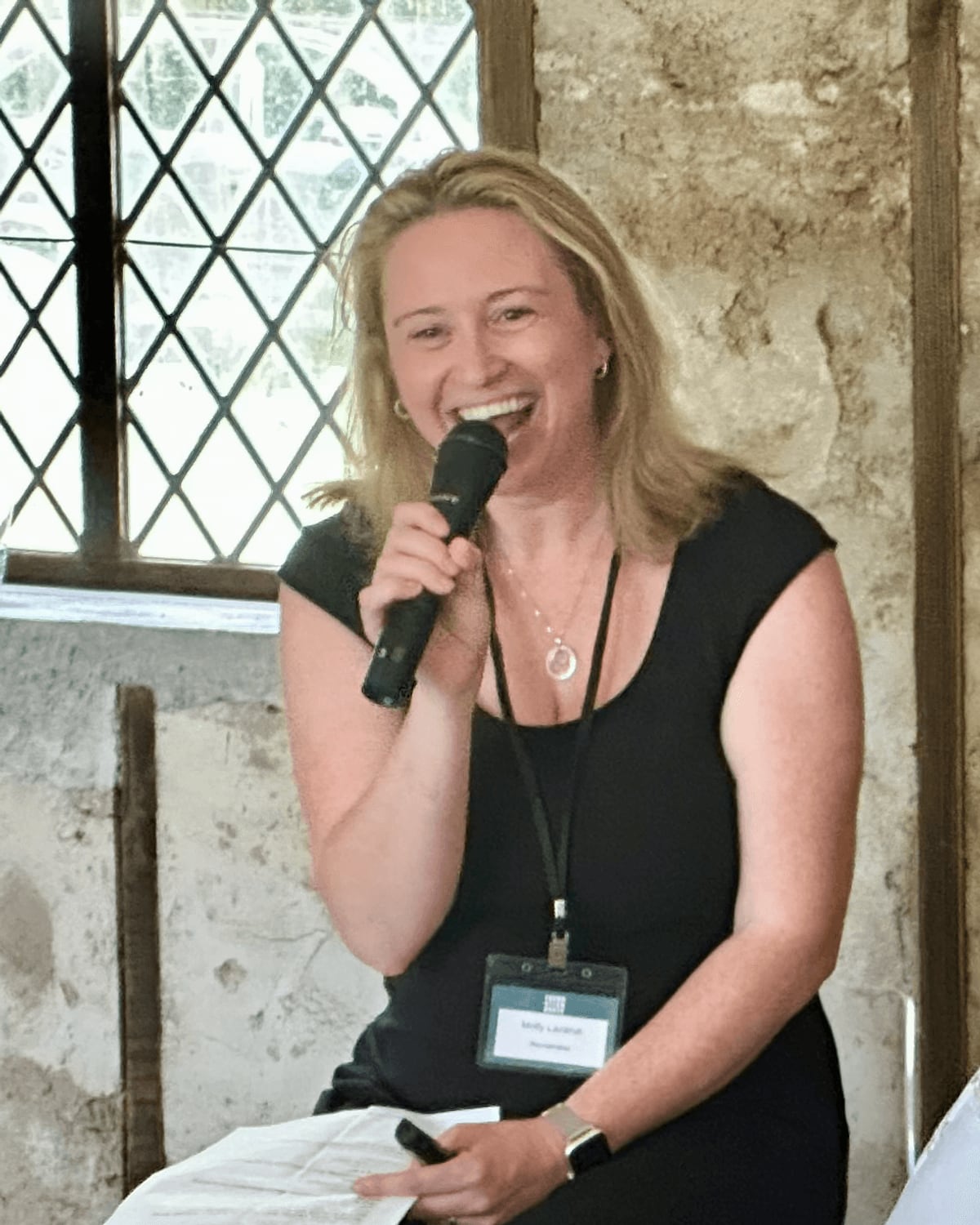 Molly Lazarus speaking with a microphone, mid-conversation